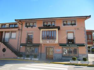 a pink building with windows and a street at Casa Pardo in Gibaja