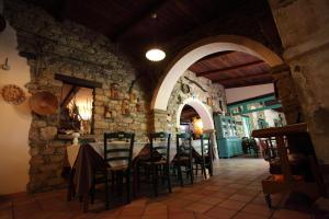 a dining room with a table and chairs in a building at Hotel Sa Lolla in Barùmini +58 photos