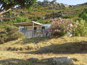 a house on top of a hill with flowers at La Canardiere in Casta