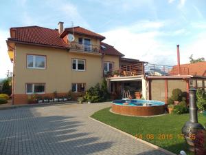 a house with a swimming pool in front of it at Apartman JaS in Liptovský Mikuláš