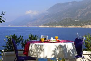 a table and chairs with a view of the ocean at Lukka Exclusive Hotel – Adult Only +12 in Kaş