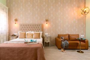 a bedroom with a large bed and a chair at Vintage Suites in Limenaria