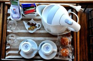 a table with a tea pot and plates and cups at Hosteria Puerto Palos in Puerto Pirámides