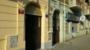 a building with two doors on the side of a street at Hugo Apartment Prague in Prague