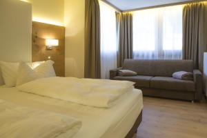 Ένα ή περισσότερα κρεβάτια σε δωμάτιο στο Hotel Collini