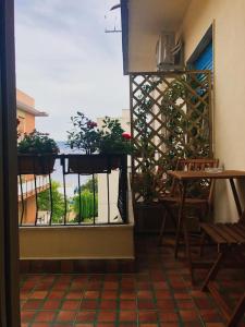 Blick auf einen Balkon mit einem Tisch und einem Fenster in der Unterkunft Paradiso Relais in Messina