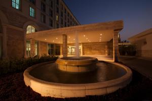 a large fountain in front of a building at night at Palm Camayenne in Conakry