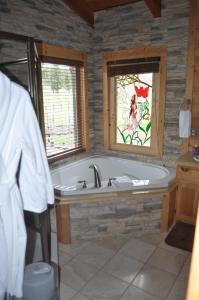 a bath tub in a bathroom with a window at Elkwood Manor Bed & Breakfast in Pagosa Springs