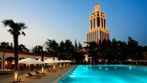 a large building with a clock tower in the background at Guest House Nadejda in Batumi