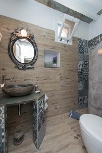 a bathroom with a sink and a mirror at Peristeronas house sifnos - Dove Cot sifnos in Apollonia