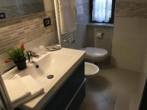 a bathroom with a white sink and a toilet at 85Centro in Potenza +26 photos