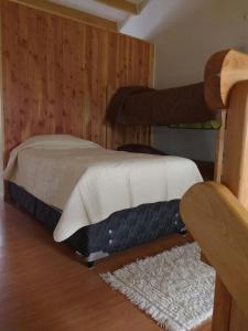 a bedroom with two bunk beds and a rug at HelChiloé Aparthotel in Castro