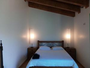 a bedroom with a bed with two lamps on it at Douro Balcony in Resende
