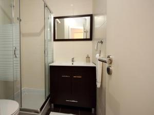 a bathroom with a sink and a shower with a mirror at Lisbon Lights Apartments in Lisbon +57 photos