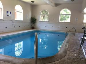 a swimming pool in a house with windows at Americas Best Value Inn and Suites Saint Charles in St. Charles