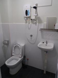 a bathroom with a toilet and a sink at JS Guest House Air Putih - Roomstay in Kuantan