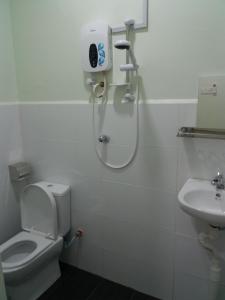 a bathroom with a shower and a toilet and a sink at JS Guest House Air Putih - Roomstay in Kuantan +22 photos