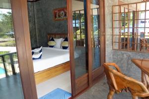 a room with a bedroom with a bed in it at Wonderland Healing Center in Thongsala
