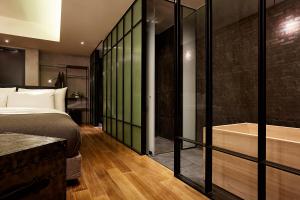 a bedroom with a bed and a bath tub at 9 Brick Hotel in Seoul