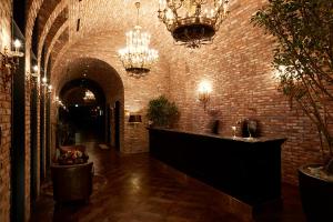 a room with a brick wall and chandeliers at 9 Brick Hotel in Seoul