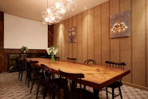 a conference room with a large wooden table and chairs at 9 Brick Hotel in Seoul
