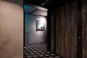 a hallway with a mirror and a checkered floor at 9 Brick Hotel in Seoul