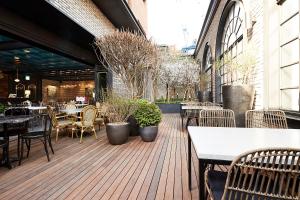 an outdoor patio with tables and chairs and tables at 9 Brick Hotel in Seoul