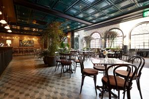 a restaurant with tables and chairs in a building at 9 Brick Hotel in Seoul