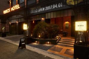 a building with a sign on the front of it at 9 Brick Hotel in Seoul