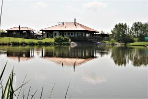 a house on the shore of a lake at Restaurace&Rooms Na Jitrách in Semice