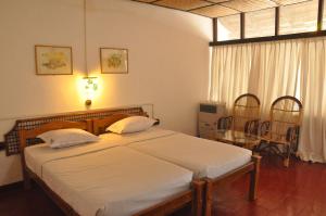 a bedroom with a large bed with white sheets at Bangaram Island Beach Resort in Bangaram Island