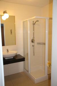 a bathroom with a shower and a sink at Weingut Schatz in Heimschuh