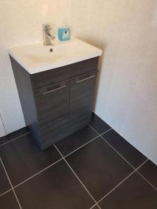 a bathroom with a sink and a tile floor at Private Home Titanic History in Belfast +9 photos