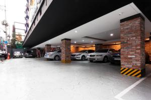 a parking lot with cars parked in a building at Hotel Leaders in Seoul