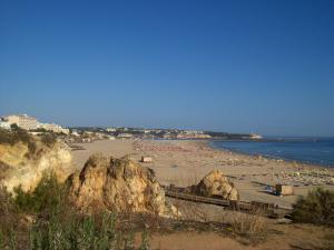 a beach with some rocks and the water and the ocean at Hotel Santa Catarina Algarve in Portimão