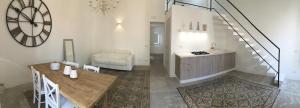 a living room with a table and a stair case at Mandralisca Garden in Cefalù