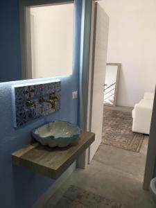 a bathroom with a bowl sink on a counter at Mandralisca Garden in Cefalù +43 photos