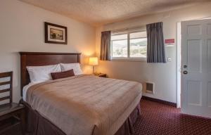 a hotel room with a bed and a window at Silver Sands in Rockaway Beach