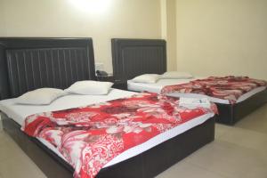 zwei Betten stehen in einem Zimmer mit in der Unterkunft Dynamic SH Resort in Cox's Bazar