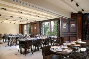 a dining room with tables and chairs and windows at Palazzo Veneziano - Venice Collection in Venice