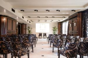 a room with rows of chairs in a room with a window at Palazzo Veneziano - Venice Collection in Venice +37 photos