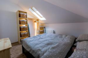 a bedroom with a bed and a shelf with baskets at Cozy Apartment - Palas in Iaşi