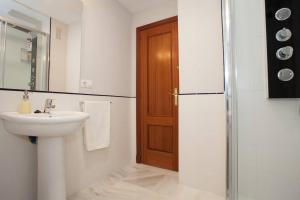 a bathroom with a sink and a refrigerator at Apartamento Castillo San Marcos in El Puerto de Santa María