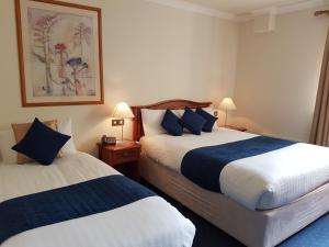 Ліжко або ліжка в номері An Cruiscin Lan