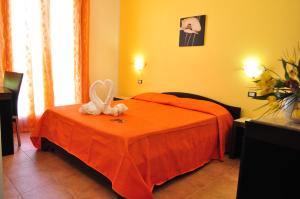a bedroom with a bed with a heart on it at Bed & Breakfast Adriana in San Vito lo Capo