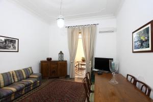 a living room with a couch and a table at Duchi in Palermo