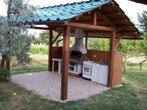 a outdoor kitchen with an outdoor oven in a garden at Casa Vacanze Good Buy in San Gimignano