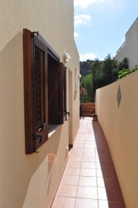an alley between two buildings with open windows at Bed & Breakfast Adriana in San Vito lo Capo
