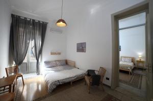 a bedroom with a bed and a window and a table at Duchi in Palermo