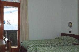 Postel nebo postele na pokoji v ubytování Hotel Davost
